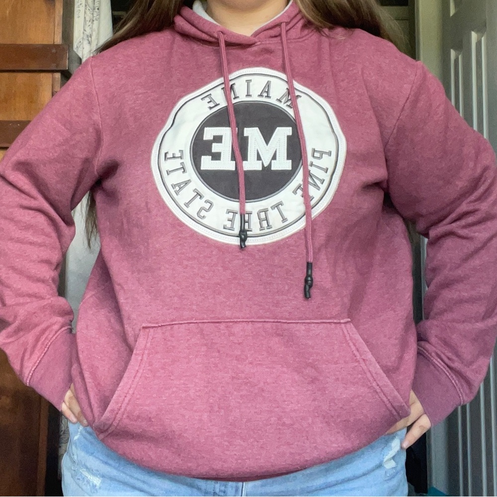 Pink Sweater with Circular Emblem Design